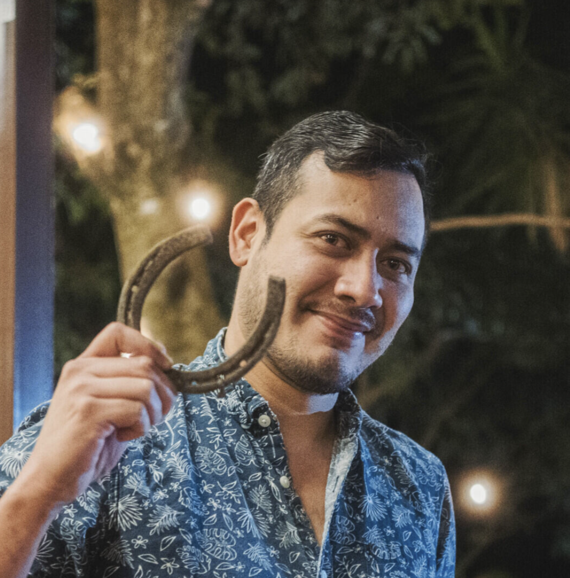 Portrait of a man with glasses wearing a gray shirt.